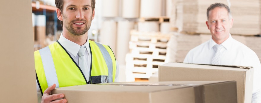 Delivery driver loading his van with boxes outside the warehouse